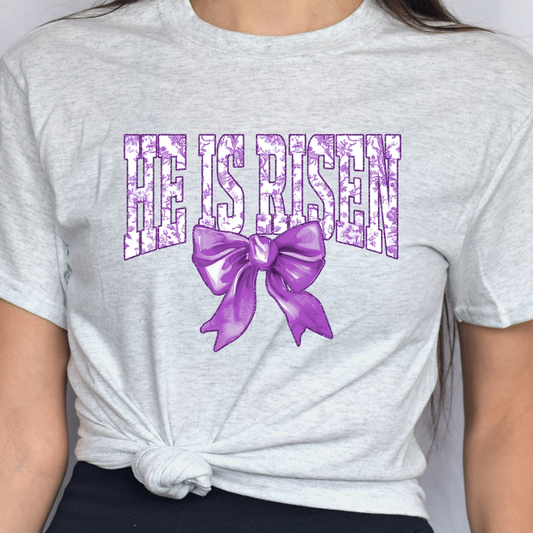 He Is Risen In Purple w/ Bow Tee